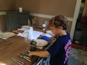 Jonah setting the table for his sister as part of her 5th grade Teshuvah dinner assignment