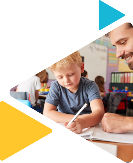 teacher smiling watching student write in notebook